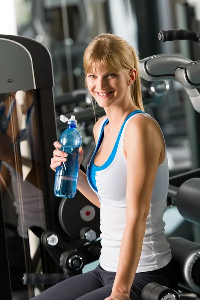 Young woman relax sit fitness machine — Stock Photo, Image