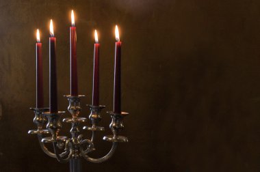Five red candles lighted on painted room clipart