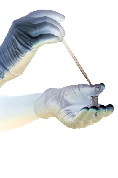 Shaded hands in gloves hold pipette — Stock Photo, Image