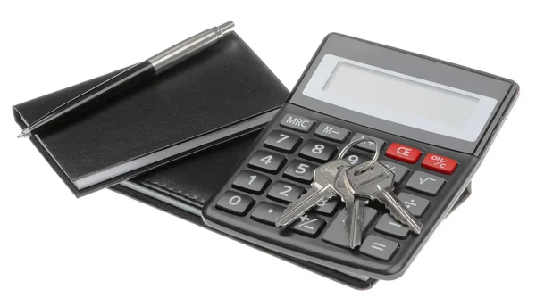 Caderno, caneta, chave e calculadora preta — Fotografia de Stock