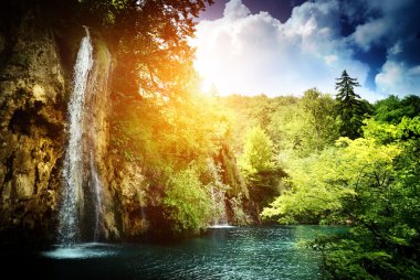 Waterfall in deep forest clipart