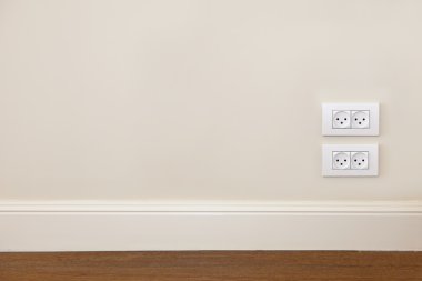 Wall with wooden floor and power outlet clipart