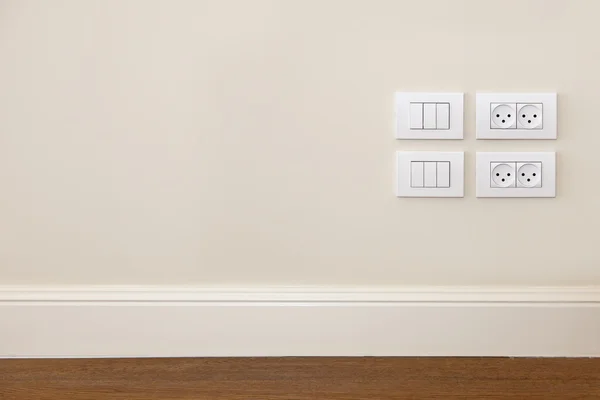 Stopcontact en licht schakelaar op de muur — Stockfoto