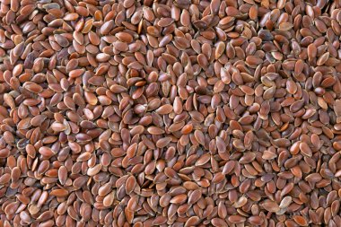 Flax seeds (Linum usitatissimum) texture background. clipart