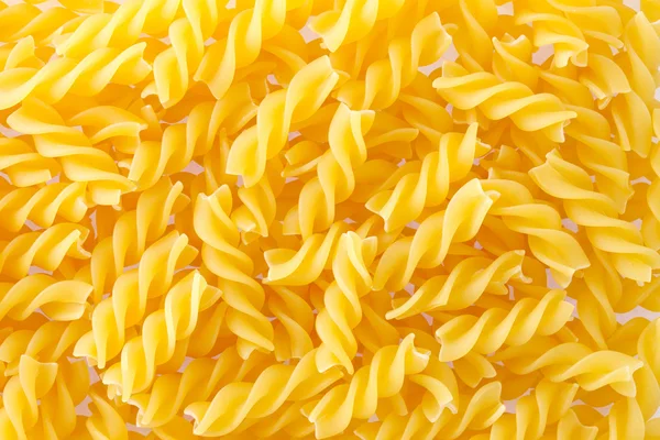 Fusilli pasta konsistens bakgrund. — Stockfoto