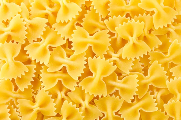 Farfalle pasta konsistens bakgrund. — Stockfoto