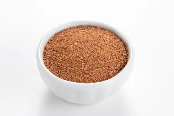 Cinnamon ground in a white bowl on white background. — Stock Photo, Image