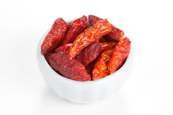 Hot chili peppers in a white bowl on white background — Stock Photo, Image