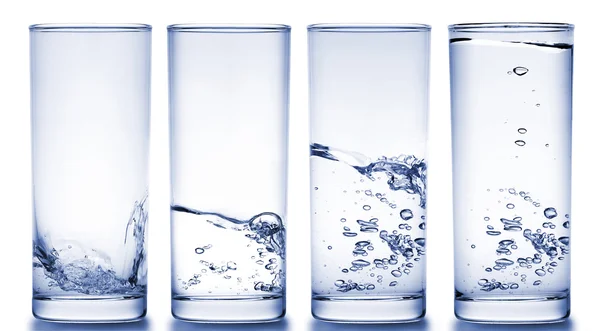 stock image Four glasses filled with water