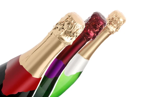 Três garrafas de champanhe em um fundo branco — Fotografia de Stock