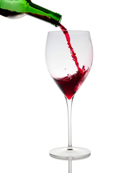 Pouring red wine in glass goblet isolated on white — Stock Photo, Image