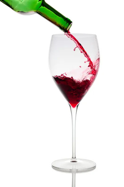 Pouring red wine in glass goblet isolated on white — Stock Photo, Image