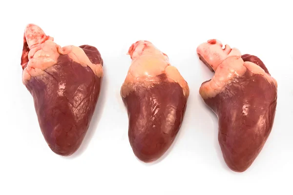 Three raw chicken hearts — Stock Photo, Image