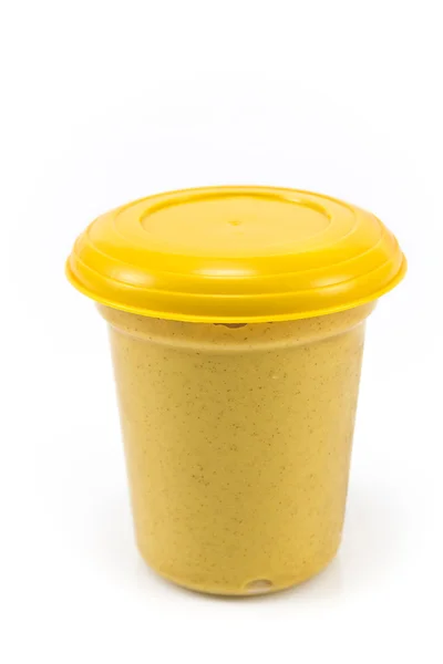 Plastic pot of of mustard — Stock Photo, Image