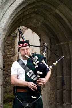 Bagpiper under Archway clipart