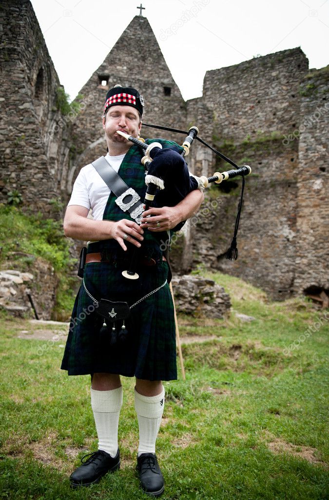 Bagpiper in an old castle — Stock Photo © tepic #9695673