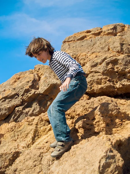 Boy playing in rocks — Stock Photo, Image