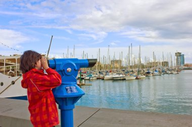 Boy in port of Barcelona, Spain clipart