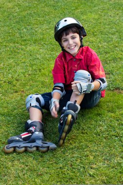 Happy boy in roller blades clipart