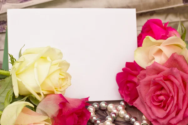 Rosas con perlas hebra y tarjeta en blanco —  Fotos de Stock