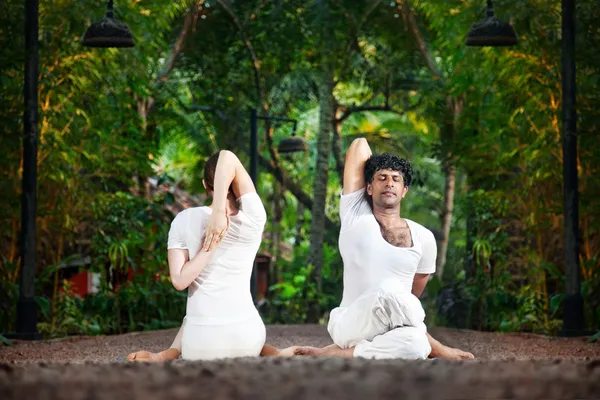 Couple yoga gomukhasana cow pose — Stock Photo, Image