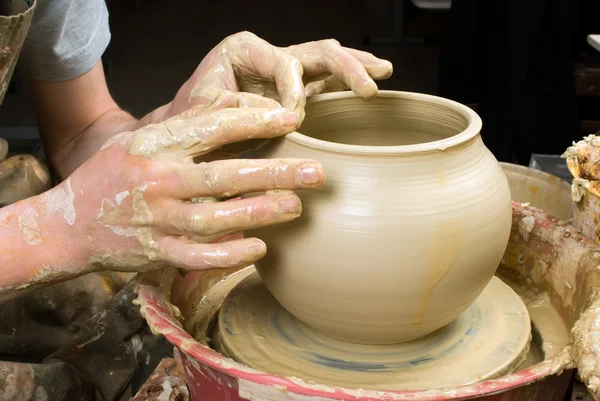 Mãos de um oleiro, criando um jarro de barro branco — Fotografia de Stock