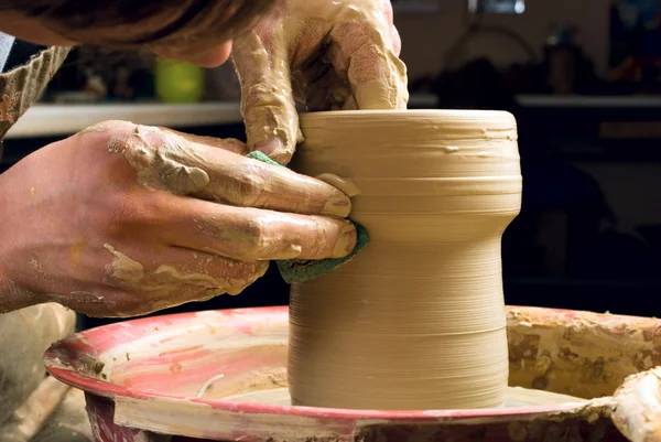 stock image Hands of a potter, creating an earthen jar of white clay