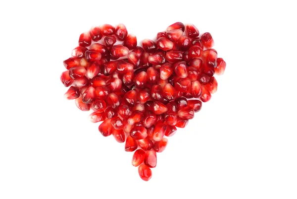 Pomegranate seeds as heart shaped isolated on white — Stock Photo, Image