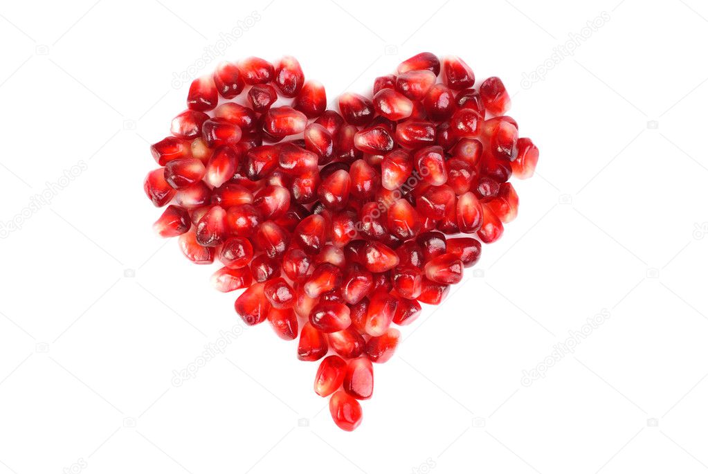 Pomegranate seeds as heart shaped isolated on white