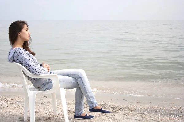 stock image Woman sitting on chair at beach