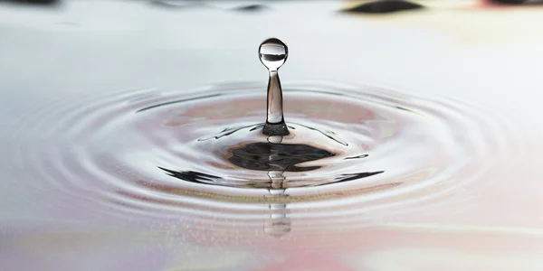 stock image Drop of pure fresh water falls in water