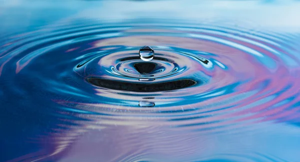 stock image Drop of pure fresh water falls in water