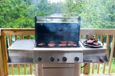 Pork steaks on gas grill clipart