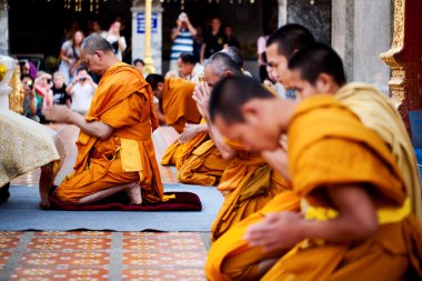 CHIANG MAI, THAILAND - FEBRUARY 4: Buddhist monks praying on eve clipart