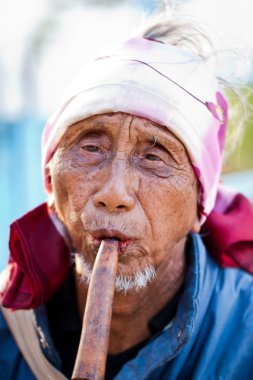 PAI, THAILAND - FEB 3: Unidentified Lahu tribe senior man plays clipart