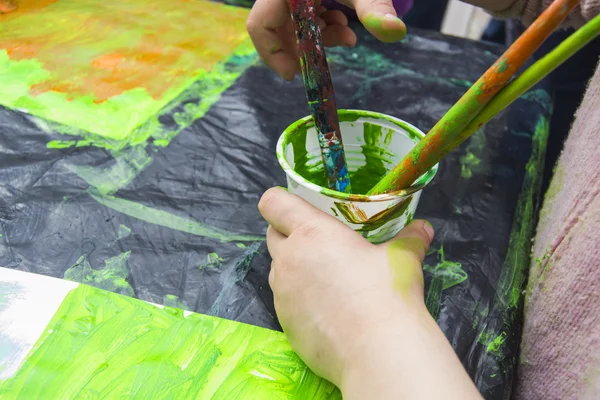 stock image Child paints with a brush