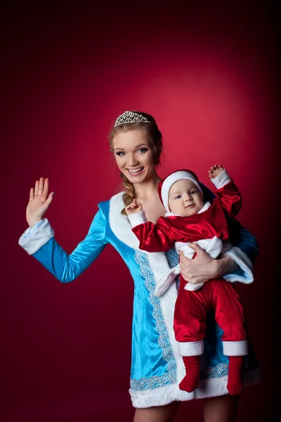 Beauty christmas girl play with baby santa claus — Stock Photo, Image