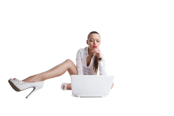 Sexy confused woman sit with laptop and long legs — Stock Photo, Image