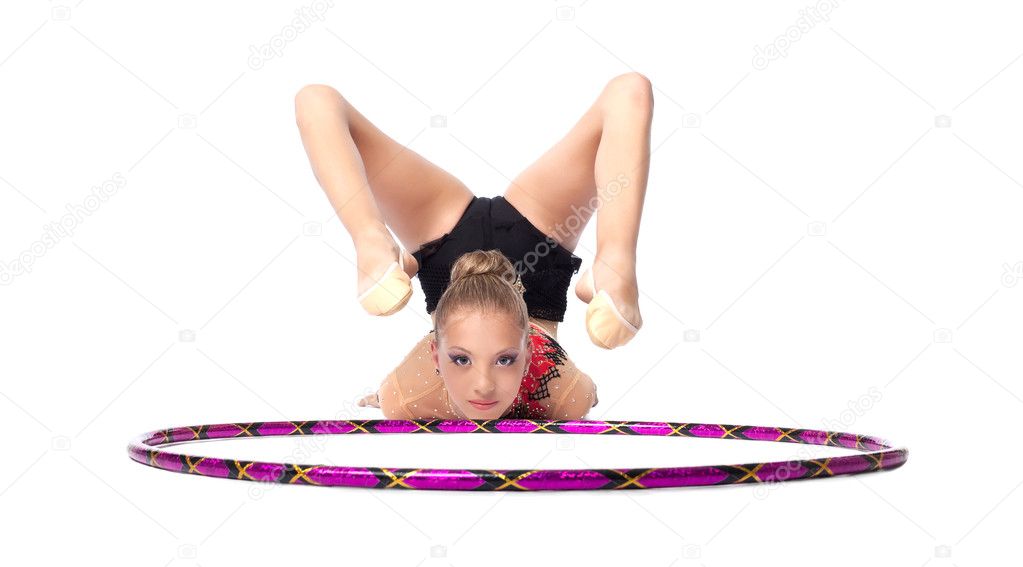 Young gymnast lay on white with hoop