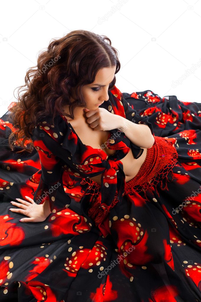 Young woman sit in gypsy black and red costume