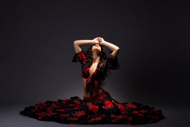 genç kadın oturup çingene siyah ve kırmızı kostümü