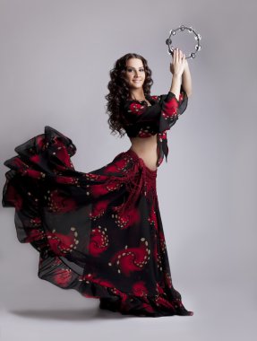 Young woman dance flamenco with tambourine clipart