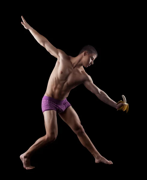 Nagi striptiz lekkoatletycznego mężczyzna pozowanie z bananem — Zdjęcie stockowe