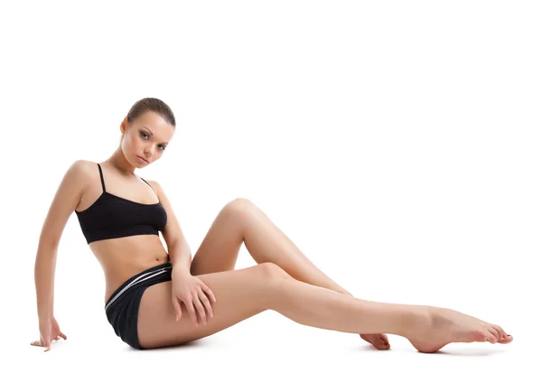 Happy young woman posing in fitness costume — Stock Photo, Image