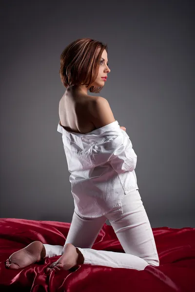 Sexy Frau posiert in weißem Hemd und Jeans — Stockfoto