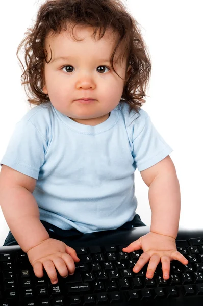 Little kid with a computer keyboard — Stock Photo, Image
