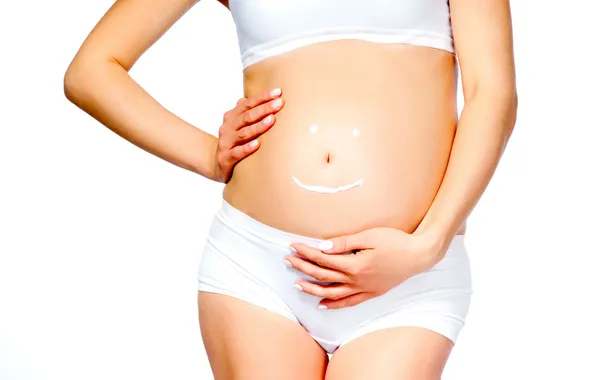 Pregnant young female with cosmetic cream — Stock Photo, Image