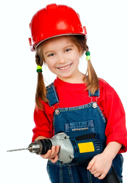 Menina no capacete de construção com uma broca — Fotografia de Stock