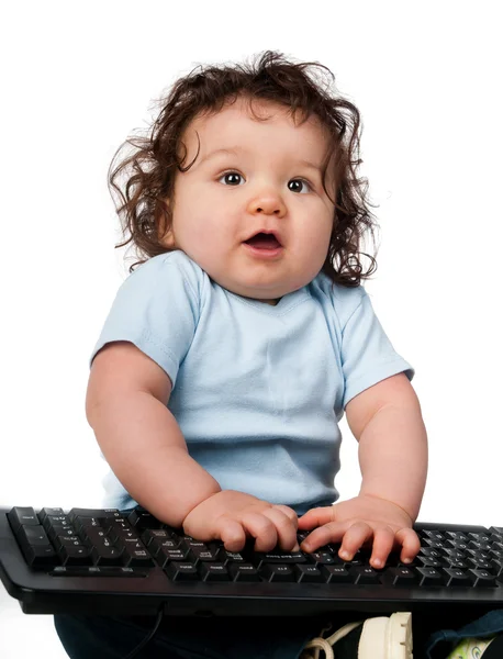 Little kid with a computer keyboard — Stock Photo, Image