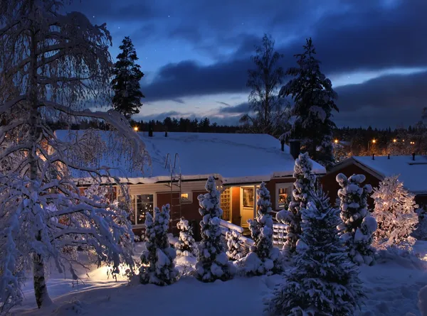 Snowy house on Christmas evening — Stock Photo, Image